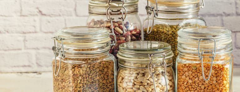Glass jars with various legumes - beans, mung bean, peas and lentils. Cooking, diet, vegan and vegetarian food.