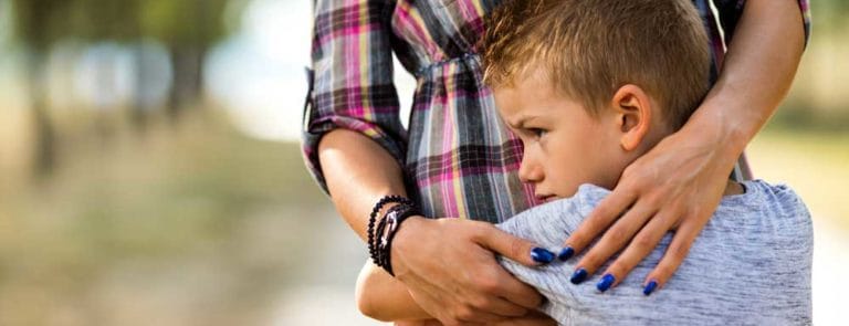 Young boy hugging his mother