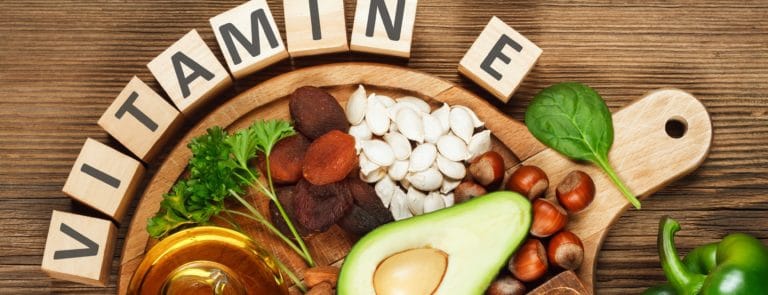 Vitamin E foods on a wooden surface