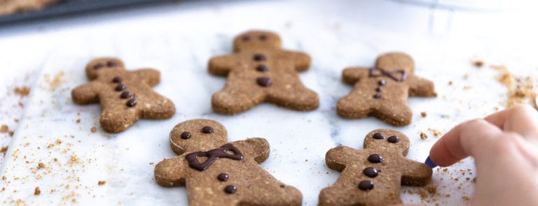 Vegan gingerbread cookies decorated with vegan dark chocolate