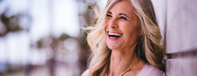 Happy middle-aged woman with greying hair