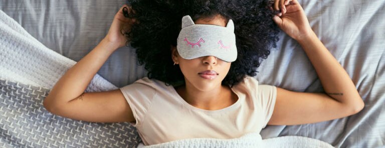 woman asleep with an eye mask