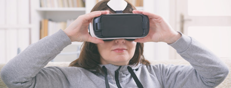 a woman using a VR mask taking part in virtual reality therapy