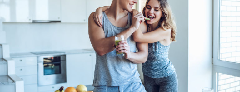 sporty couple preparing a healthy meal after their workout