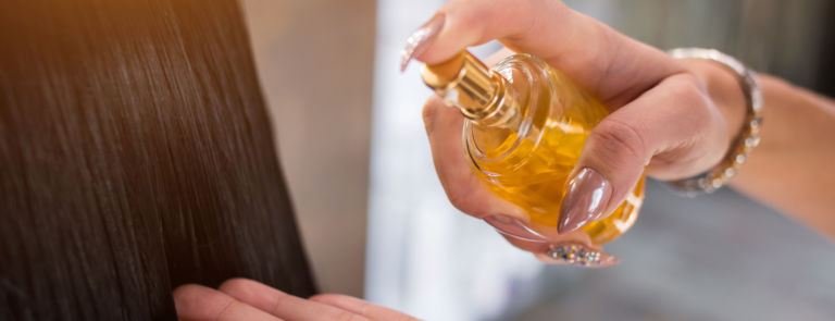 woman using hair oil