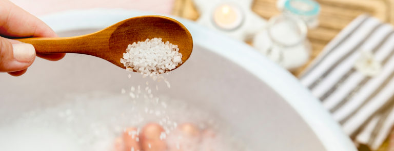What is Epsom salt? Best uses of Epsom salts including foot soak, exfoliant, and gargling. How to boost your magnesium levels and relax tired muscles.