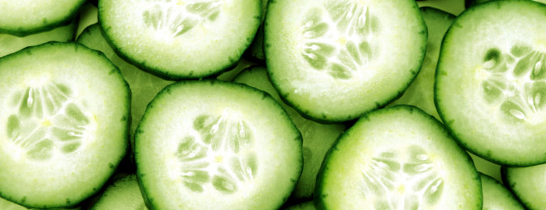 Many fresh cucumber slices, on top of eachother.
