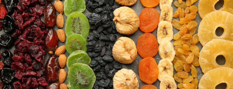 An array of dried fruits, spread out into lines going vertically down the image.