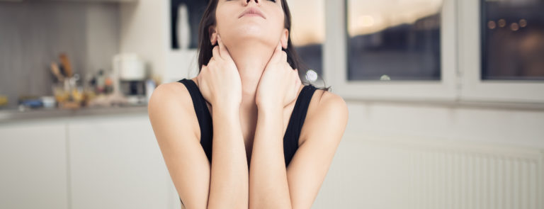 Anxious looking woman in kitchen with coffee