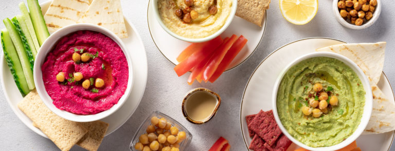 Hummus and dip selection with carrots and chickpeas in a bowl.