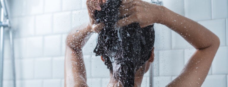 A young asian women washing her hair in the shower